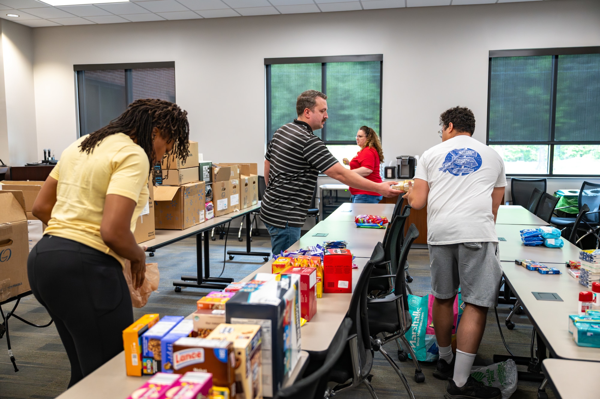 Airmen from the Arnold Engineering Development Complex Enlisted Force Council at Arnold Air Force Base, Tenn., recently volunteered their time at the Jack Daniel Distillery in Lynchburg, Tenn. The Airmen sorted and packed donated items bound for the USO at U.S. Army Garrison, Fort Campbell in Kentucky. The USO will distribute the care packages to deployed service personnel. (U.S. Air Force photo by Kali Bradford)