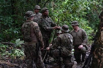 U.S. Soldiers and Airmen, along with members of the Suriname Armed Forces, construct survival structures during Operation Rumble in the Jungle at Ayoko, Suriname, April 17, 2026.
