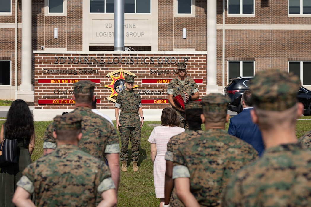 U.S. Marine Corps Brig. Gen. Maura M. Hennigan, center, the commanding general of 2nd Marine Logistics Group, speaks prior to an award ceremony recognizing the work of 2nd MLG federal civilian employees at Marine Corps Base Camp Lejeune, North Carolina, May 11, 2026. The ceremony highlighted the contributions of 2nd MLG equal opportunity advisors and sexual assault response coordinators, alongside personnel recognized for 15 and 40 years of service to the federal government. Hennigan is a native of New York. (U.S. Marine Corps photo by Sgt. Rafael Brambila-Pelayo)