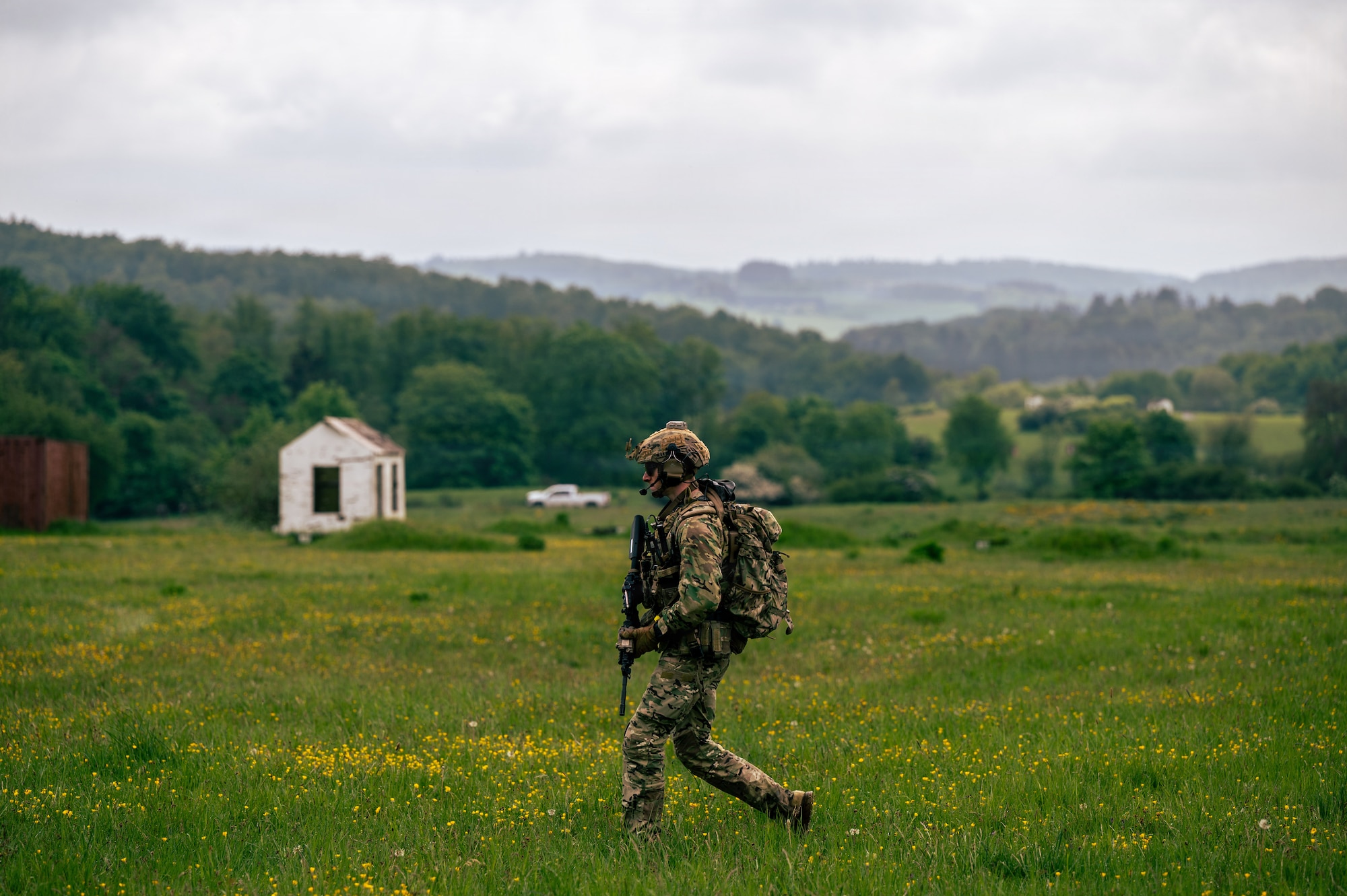 U.S. Air Force Staff Sgt. Anthony Granata, 786th Civil Engineer Squadron Explosive Ordnance Disposal flight team leader, walks across a field