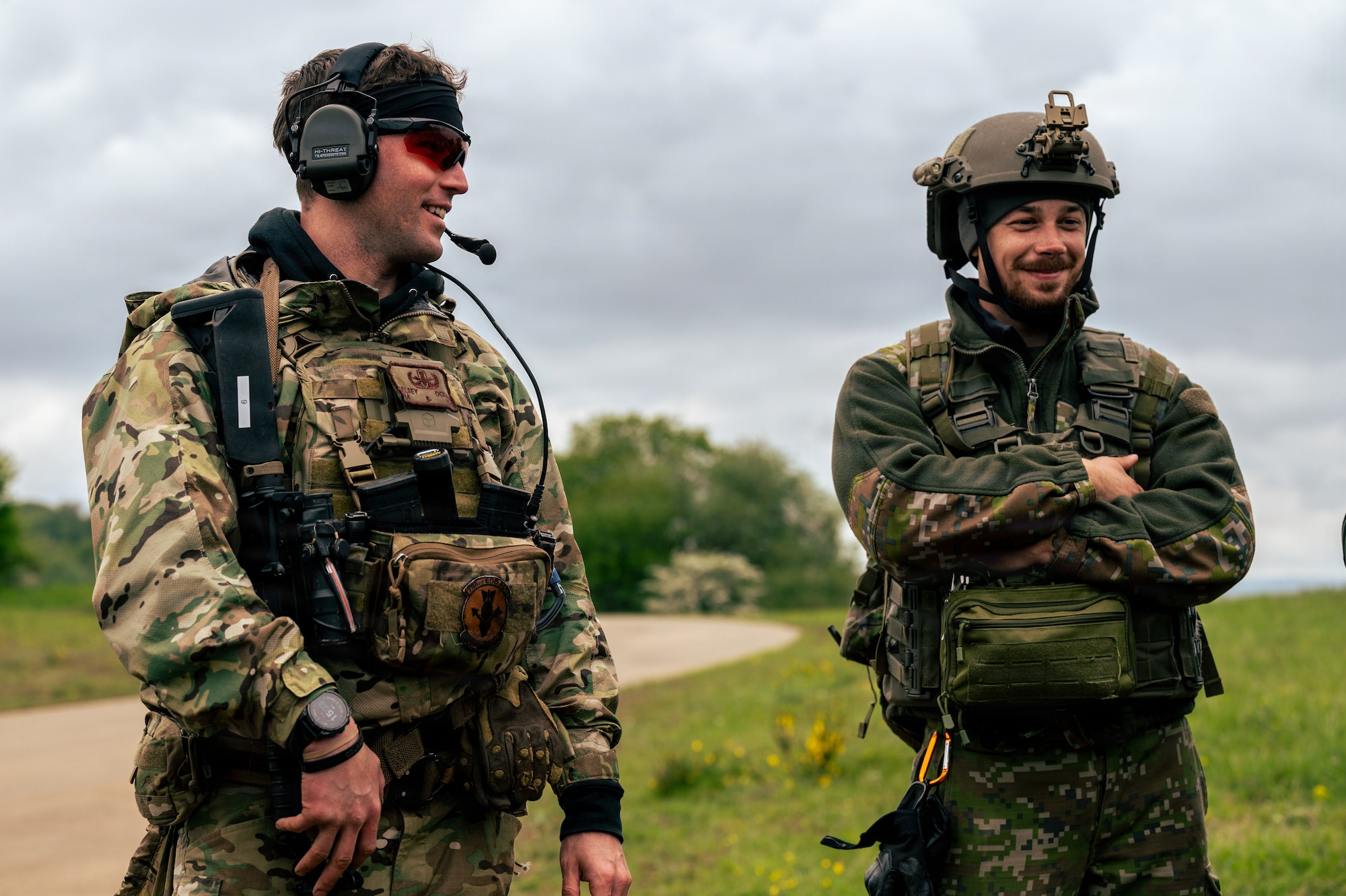 U.S. Air Force Senior Airman Kelsey Ockman, 786th Civil Engineer Squadron Explosive Ordnance Disposal flight team member, left, speaks with a Slovak Air Force service member
