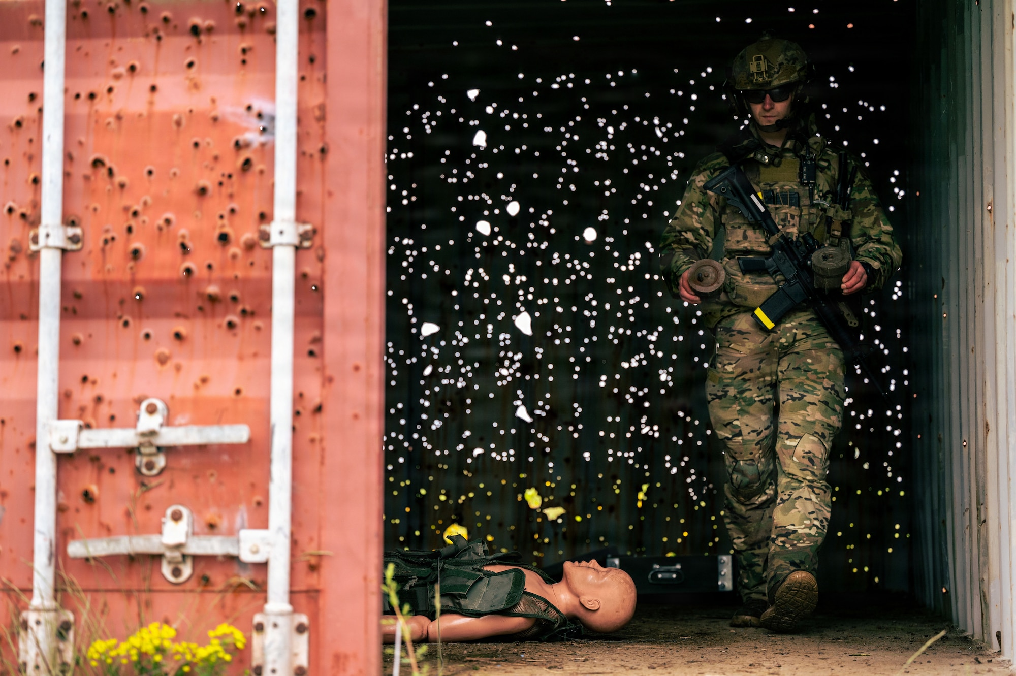 U.S. Air Force Staff Sgt. Anthony Granata, 786th Civil Engineer Squadron Explosive Ordnance Disposal flight team leader, simulates removing a landmine from a shelter