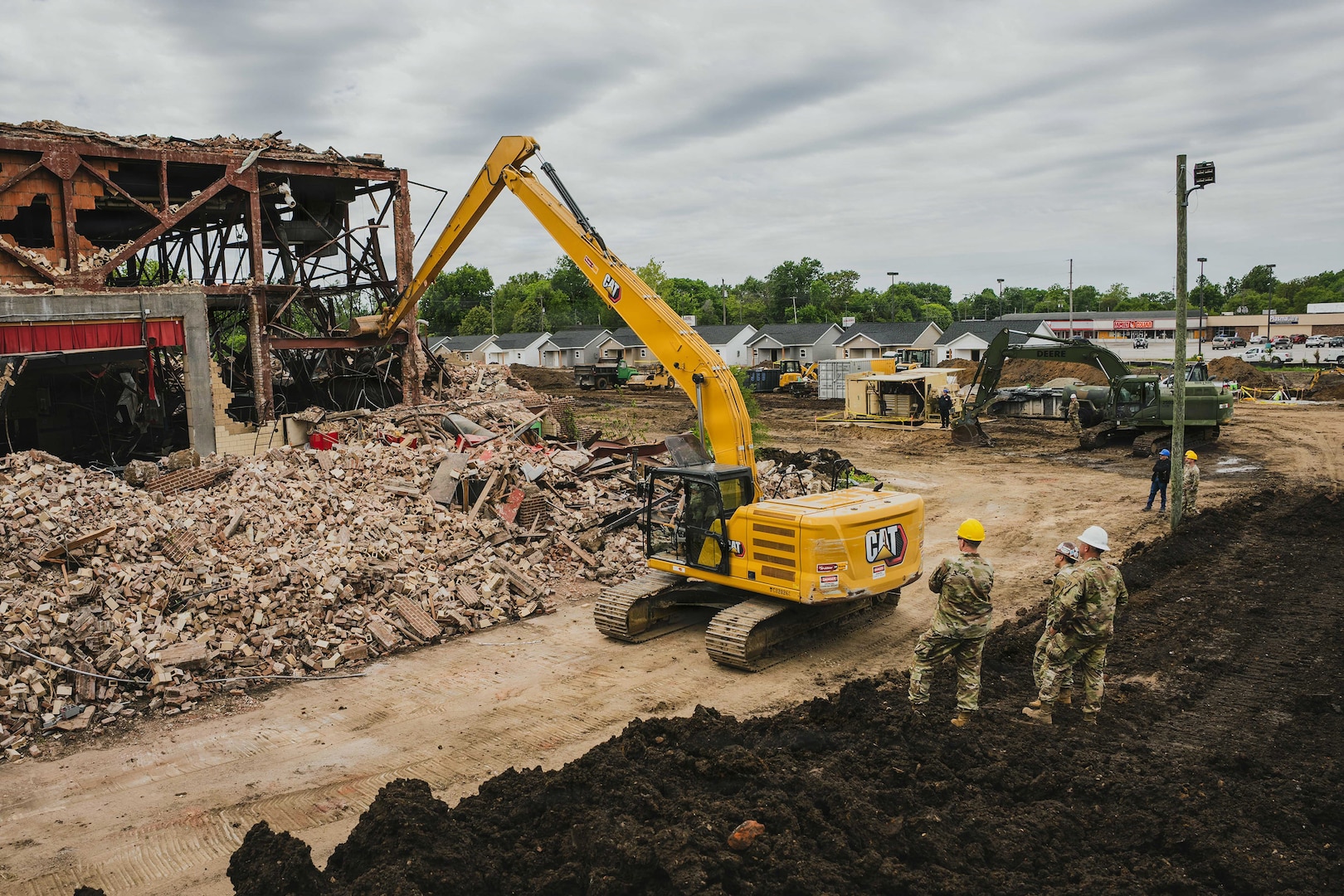 An Indiana National Guardsman with the 113th Engineer Battalion operates an excavator to demolish a building as part of an Innovative Readiness Training, or IRT, in partnership with the city of Terre Haute, Indiana, May 8, 2026.