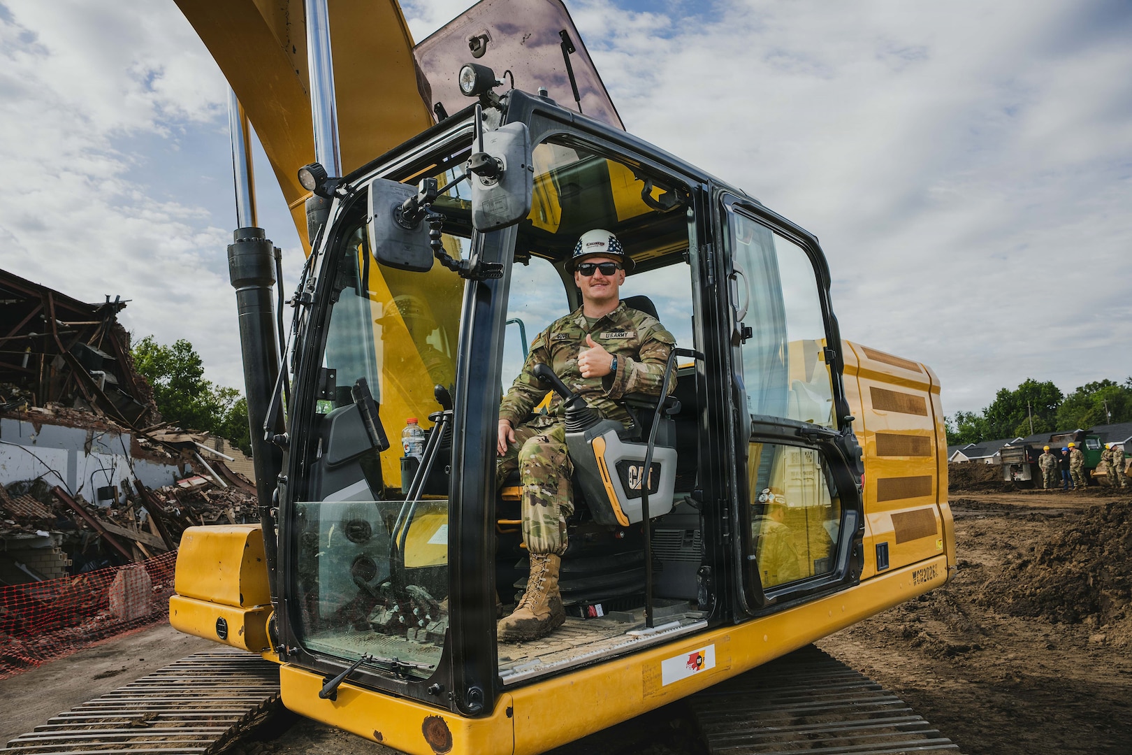 Indiana National Guard Sgt. Alexander Sovel, a construction engineer with the 113th Engineer Battalion, poses for a photo after operating an excavator to demolish a building as part of an Innovative Readiness Training, or IRT, in partnership with the city of Terre Haute, Indiana, May 8, 2026.