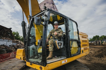 Indiana National Guard Sgt. Alexander Sovel, a construction engineer with the 113th Engineer Battalion, poses for a photo after operating an excavator to demolish a building as part of an Innovative Readiness Training, or IRT, in partnership with the city of Terre Haute, Indiana, May 8, 2026.