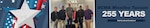 A group stands in an office lobby and poses for a picture