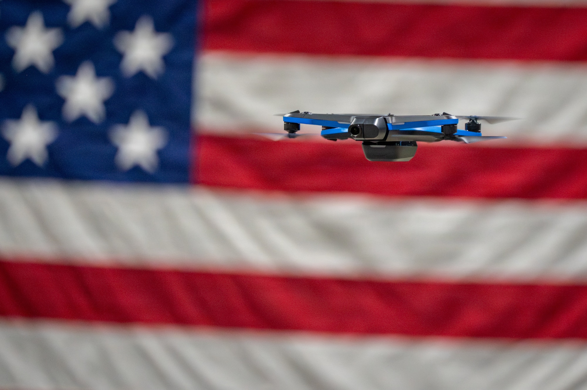 A quadcopter drone hovers in an indoor training area on Joint Base Elmendorf-Richardson, Alaska, Jan. 28, 2026. Small unmanned aerial systems are often equipped with high-definition cameras and can pose a threat to the safety and security of military installations. (U.S. Air Force photo by Airman 1st Class Theodore Gowdy)