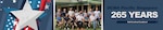 A group poses for a photo outdoors and stands in front of a building