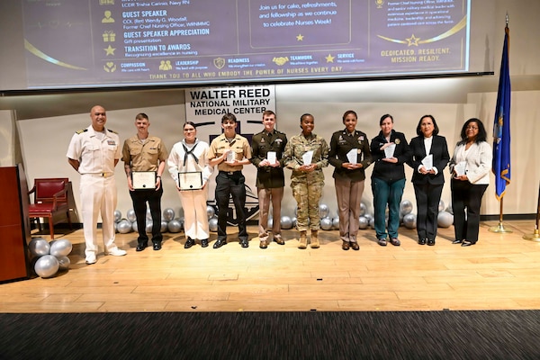 BETHESDA, Md. (May 8, 2026) Capt. Robert Cuento, the chief nursing officer assigned to Navy Medicine Readiness and Training Command (NMRTC) Bethesda poses for a photo with awardees at “The Power of Nurses” award ceremony during Nurses Week at Walter Reed National Military Medical Center, May 8, 2026. NMRTC Bethesda mission is to maximize warfighter performance through optimized medical readiness tailored to operational requirements; enhance the readiness of the medical force to sustain expeditionary medical capability; and train and develop the Navy Medicine Force. (U.S. Navy photo Mass Communication Specialist Second Class Alec Kramer)