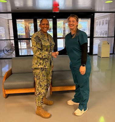 Capt. Janiese Cleckley (left), commanding officer of Navy Medicine Readiness and Training Command Twentynine Palms and director of Naval Hospital Twentynine Palms, presents Cailin Morales with a command challenge coin for superior customer service during a leadership visit to Navy Medicine Readiness and Training Unit China Lake and Branch Health Clinic China Lake at Naval Air Weapons Station China Lake, California, April 28, 2026. Cleckley recognized Sailors and civilian staff whose professionalism and dedication support patient care, operational readiness, and Navy Medicine’s mission of maintaining a medically ready force and ready medical force. (U.S. Navy photo by Hospital Corpsman 3rd Class Rebecca Duran)