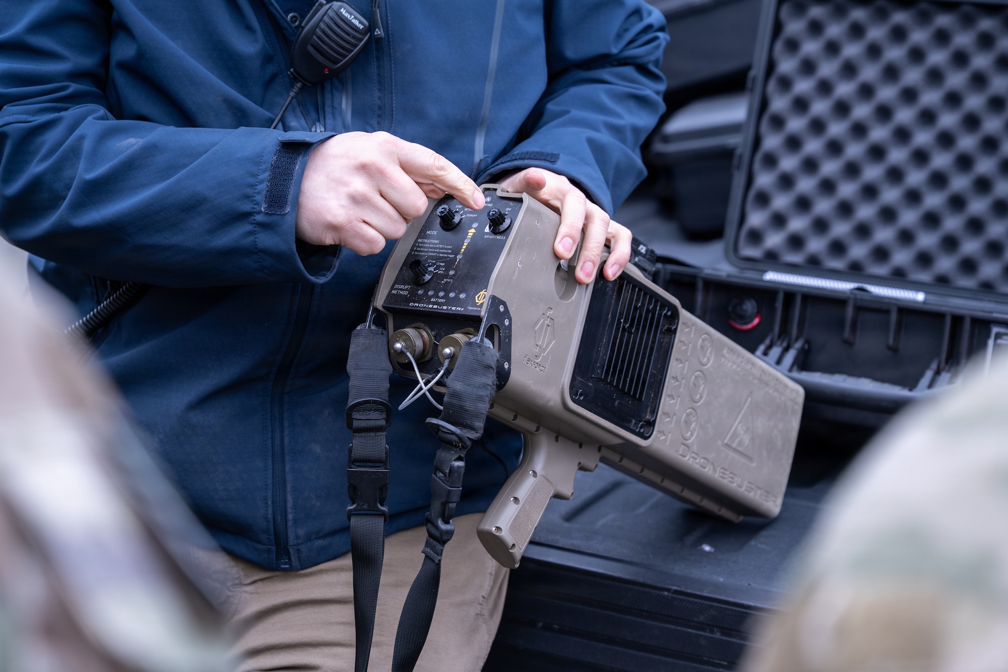 A member of the Joint Base Elmendorf-Richardson Home-Station Training Team provides instruction on the Dronebuster on JBER, Alaska, May 7, 2026. The Dronebuster is a handheld, electronic detect and defeat system used to counter small unmanned aerial systems. (U.S. Air Force photo by Airman 1st Class Theodore Gowdy)