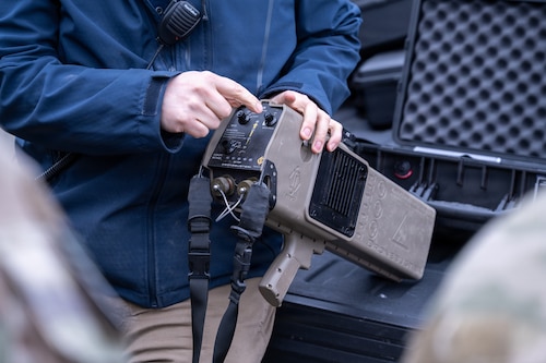 A member of the Joint Base Elmendorf-Richardson Home-Station Training Team provides instruction on the Dronebuster on JBER, Alaska, May 7, 2026. The Dronebuster is a handheld, electronic detect and defeat system used to counter small unmanned aerial systems. (U.S. Air Force photo by Airman 1st Class Theodore Gowdy)