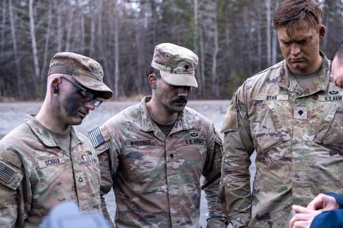 U.S. Army Pfc. Matthew Shalk, Spc. Roberto Whedbee and Spc. Chase Dowden, asssigned to A Company, 3rd Battalion, 509th Parachute Infantry Regiment, 11th Airborne Division, recieve familiarization training on the Dronebuster on Joint Base Elmendorf-Richardson, Alaska, May 7, 2026. The Dronebuster is a handheld jammer that provides a localized electronic warfare capability, allowing soldiers to disrupt and neutralize unmanned aerial systems at the tactical level. (U.S. Air Force photo by Airman 1st Class Theodore Gowdy)