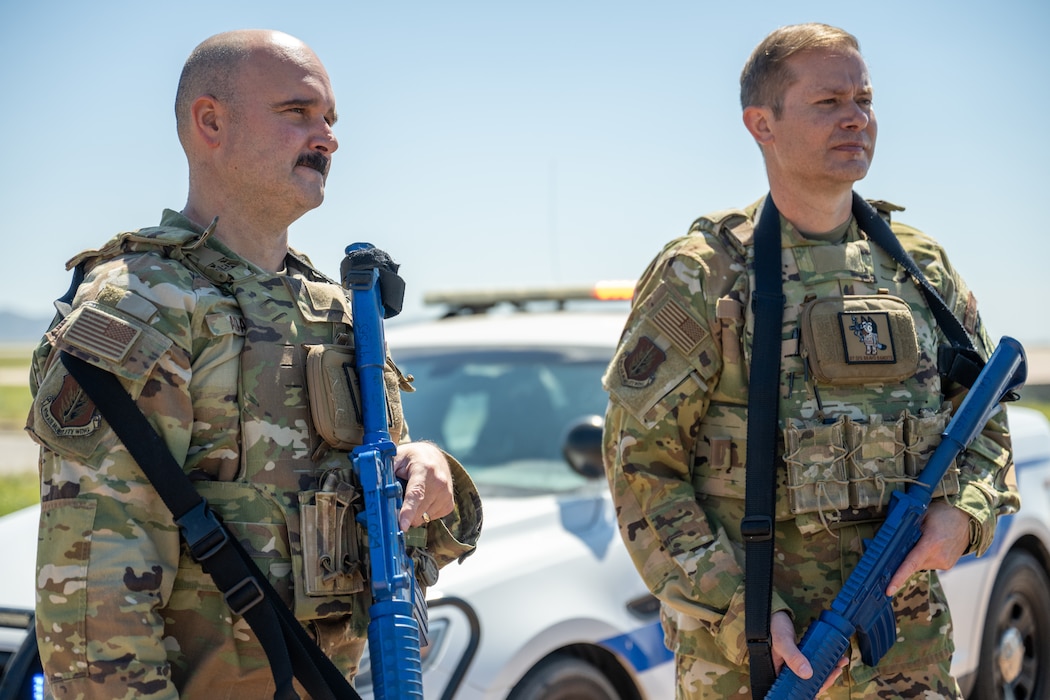 U.S. Air Force Col. Richard Kind, 97th Air Mobility Wing commander, right, and Chief Master Sgt. Jonny Adams, 97th AMW command chief, left, participate in a high-risk traffic stop demonstration at Altus Air Force Base, Oklahoma, May 7, 2026. The demonstration showed the command team how 97th Security Forces Squadron Defenders respond to elevated-threat situations while maintaining safety, control and communication. (U.S. Air Force photo by Airman 1st Class Nathan Langston)