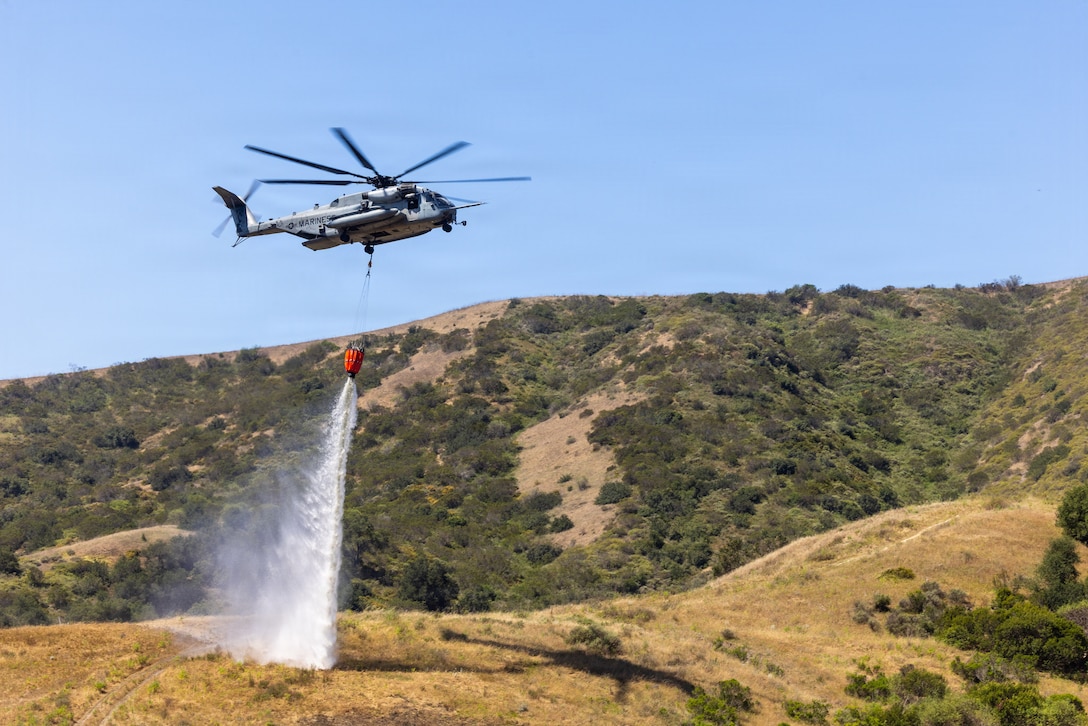 A U.S. Marine Corps CH-53E Super Stallion assigned to Marine Heavy Helicopter Squadron 462, Marine Aircraft Group 16, 3rd Marine Aircraft Wing, drops water from a Bambi firefighting bucket over a target area during the annual Cory Iverson Wildland Firefighting exercise at Las Pulgas Lake, Marine Corps Base Camp Pendleton, Calif., May 7, 2026. The Cory Iverson Wildland Firefighting exercise is an annual event focusing on interagency cooperation between the California Department of Forestry and Fire Protection, San Diego County Sheriff’s Department, the Camp Pendleton Fire Department and the Department of War. During the exercise, each entity works together with local, state and federal partner agencies to create an effective, efficient and well-trained team that provides mutual aid to better protect installations within Marine Corps Installations West and the surrounding local communities. (U.S. Marine Corps photo by Cpl. Martinez)