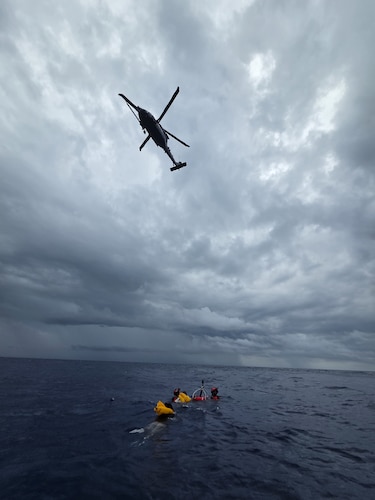 Helicopter hovering over ocean