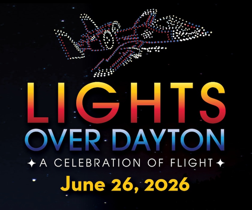 a black background showcases an airplane made up of red and white drone lights with text underneath reading Lights Over Dayton: A Celebration of Flight, June 26, 2026.