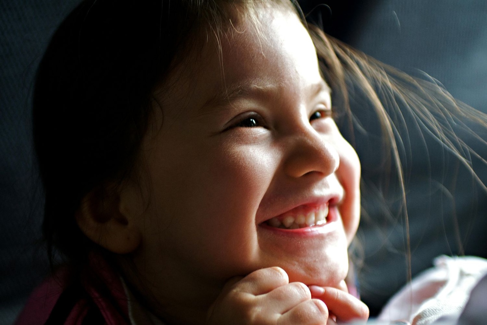 Close up photo of a young girl smiling.