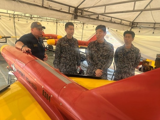 U.S. Indo-Pacific Command J7 Pacific Multi-Domain Training and Experimentation Capability Range Lead, Dave Bednarcik briefs observers from the Japan Air Self-Defense Force on high value targets employed during the combined live fire integrated air missile defense exercise at Naval Station Leovigildo Gantioqui, Zambales, Philippines, April 25, 2026, during Balikatan 2026.