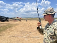 U.S. Marine Corps 1st Lt. James Botelho, 3rd Marine Littoral Regiment, 3rd Low Altitude Air Defense Battalion Liaison Officer, monitors the high-speed aerial target drone launch at the integrated air missile defense exercise at Naval Station Leovigildo Gantioqui, Zambales, Philippines, April 28, 2026, during Balikatan 2026.