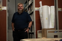 a person stands surrounded by files