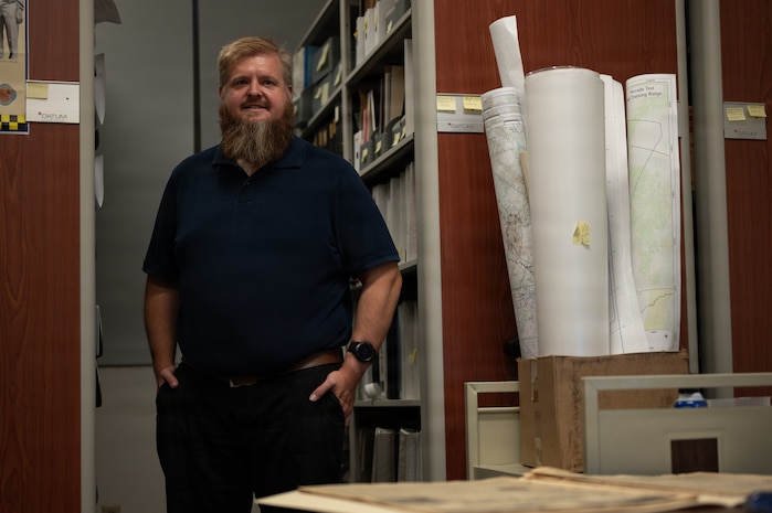 a person stands surrounded by files