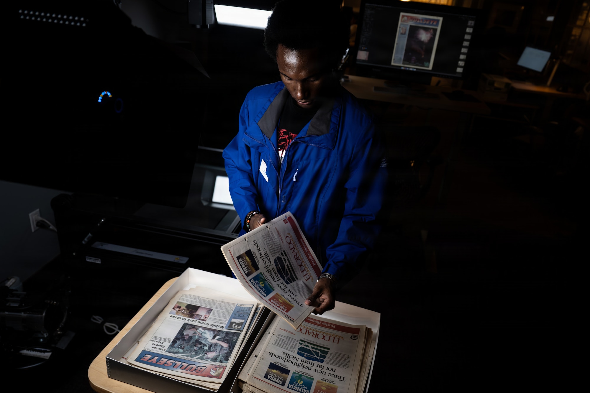 a person inspects newspapers