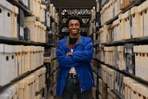 a person stands surrounded by files