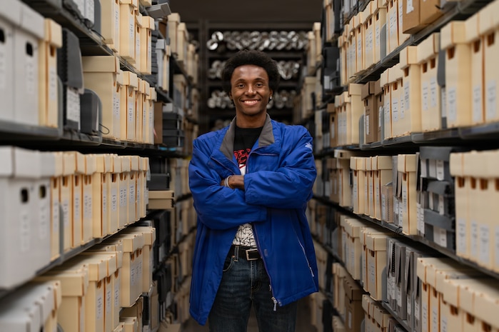 a person stands surrounded by files