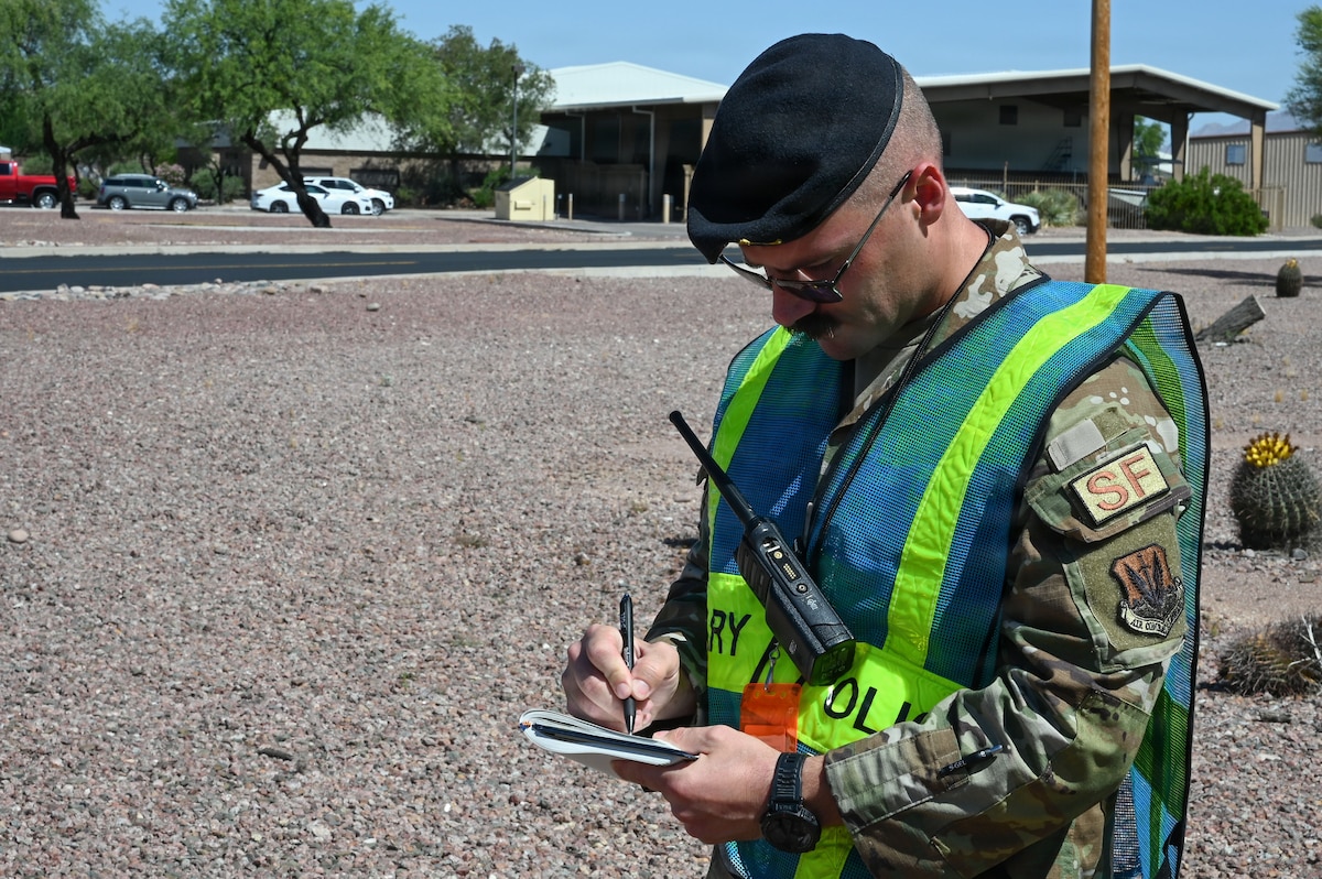 U.S. Air Force Tech. Sgt. Jacob Duncan, 355th Security Forces Squadron wing inspection team member, evaluates the squadron’s response to a simulated explosive found in an abandoned vehicle during Mosaic Lightning 26-2 at Davis-Monthan Air Force Base, Arizona, May 8, 2026. Relentless training and operational focus during combat readiness exercises like Mosaic Lightning 26-2 ensure Airmen are ready to meet any challenge with precision and professionalism. (U.S. Air Force photo by Staff Sgt. Kahdija Slaughter)