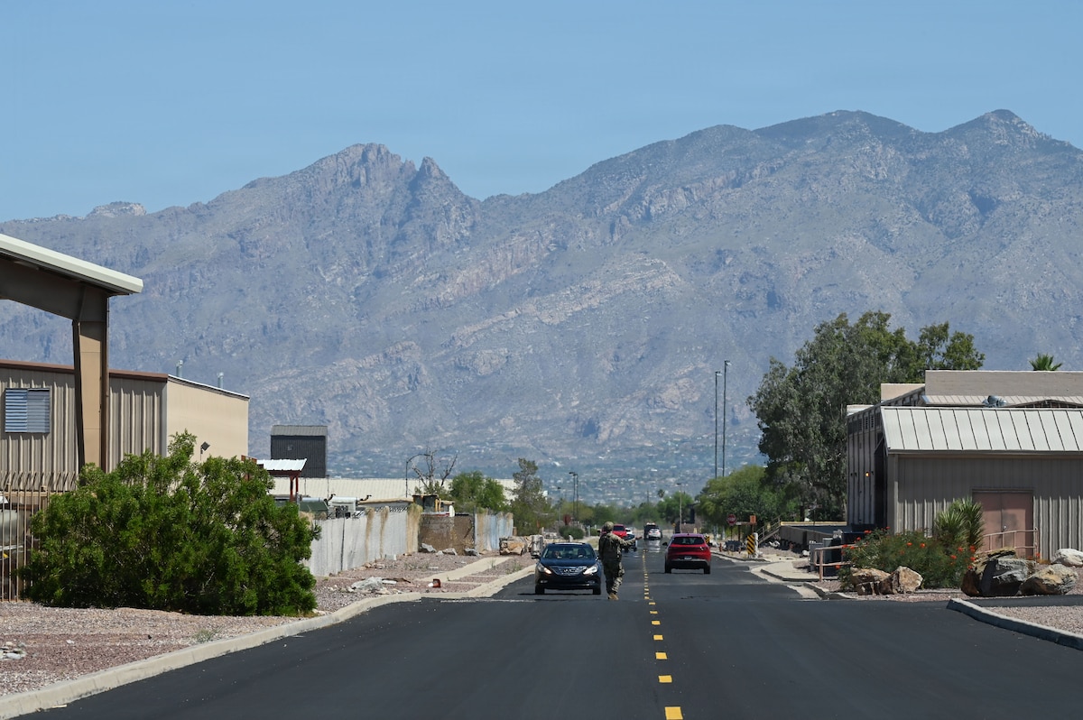 An Airman assigned to the 355th Security Forces Squadron diverts traffic to maintain a security cordon during Mosaic Lightning 26-2 at Davis-Monthan Air Force Base, Arizona, May 8, 2026. The cordon was established after Military Working Dog Oko alerted his handler of a simulated explosive device in an abandoned vehicle. A robust base defense ensures Airmen are prepared to counter threats from the inside out – making Air Force bases a hard target from every angle. Air Combat Command relies on a seamless network to remain ready to fight. (U.S. Air Force photo by Staff Sgt. Kahdija Slaughter)
