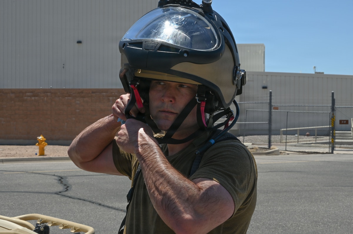 U.S. Air Force Tech. Sgt. Bruce Noble, 355th Civil Engineer Squadron explosive ordnance disposal team leader, removes an EOD bomb suit helmet during exercise Mosaic Lightning 26-2 at Davis-Monthan Air Force Base, Arizona, May 8, 2026. The bomb suit is designed to protect EOD Airmen from planned and unplanned detonations. In the face of complex threats, warrior ethos drives disciplined execution and a shared mission focus, enabling Air Combat Command to maintain its edge in contested domains. (U.S. Air Force photo by Staff Sgt. Kahdija Slaughter)