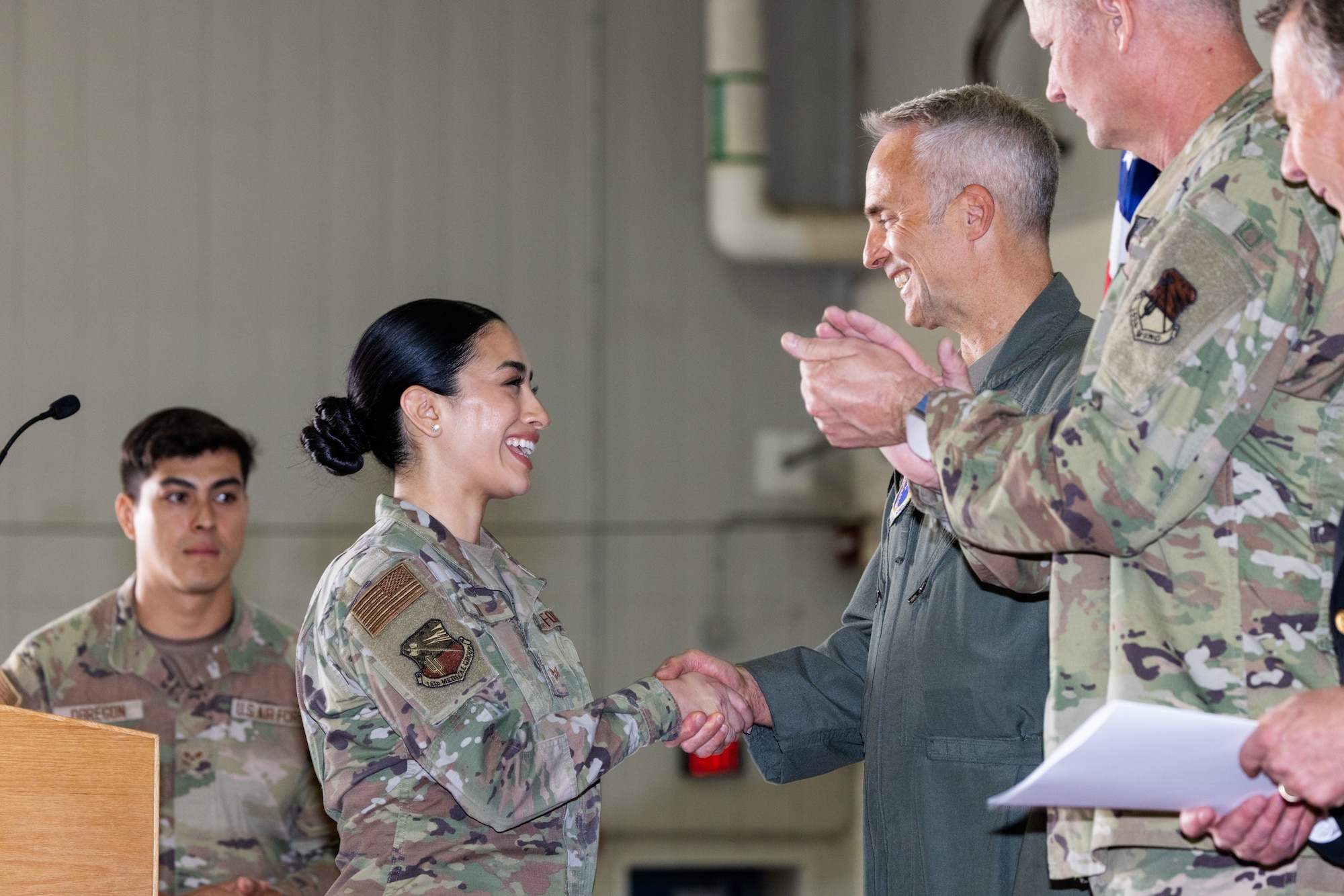 Senior Airman Nicolle Coy, an aerospace medical services specialist assigned to the 162nd Wing Medical Group, receives recognition from leadership with the Tucson Fire Department during the Wing Annual Awards held here, May 3, 2026. Coy rendered aid to a critically injured civilian and assisted firefighter with emergency medical procedures before the patient was transported to a local hospital. (U.S. Air National Guard photo by Tech. Sgt. Hampton Stramler)