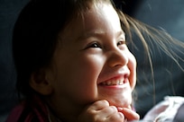 Close up photo of a young girl smiling.
