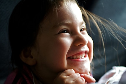 Close up photo of a young girl smiling.
