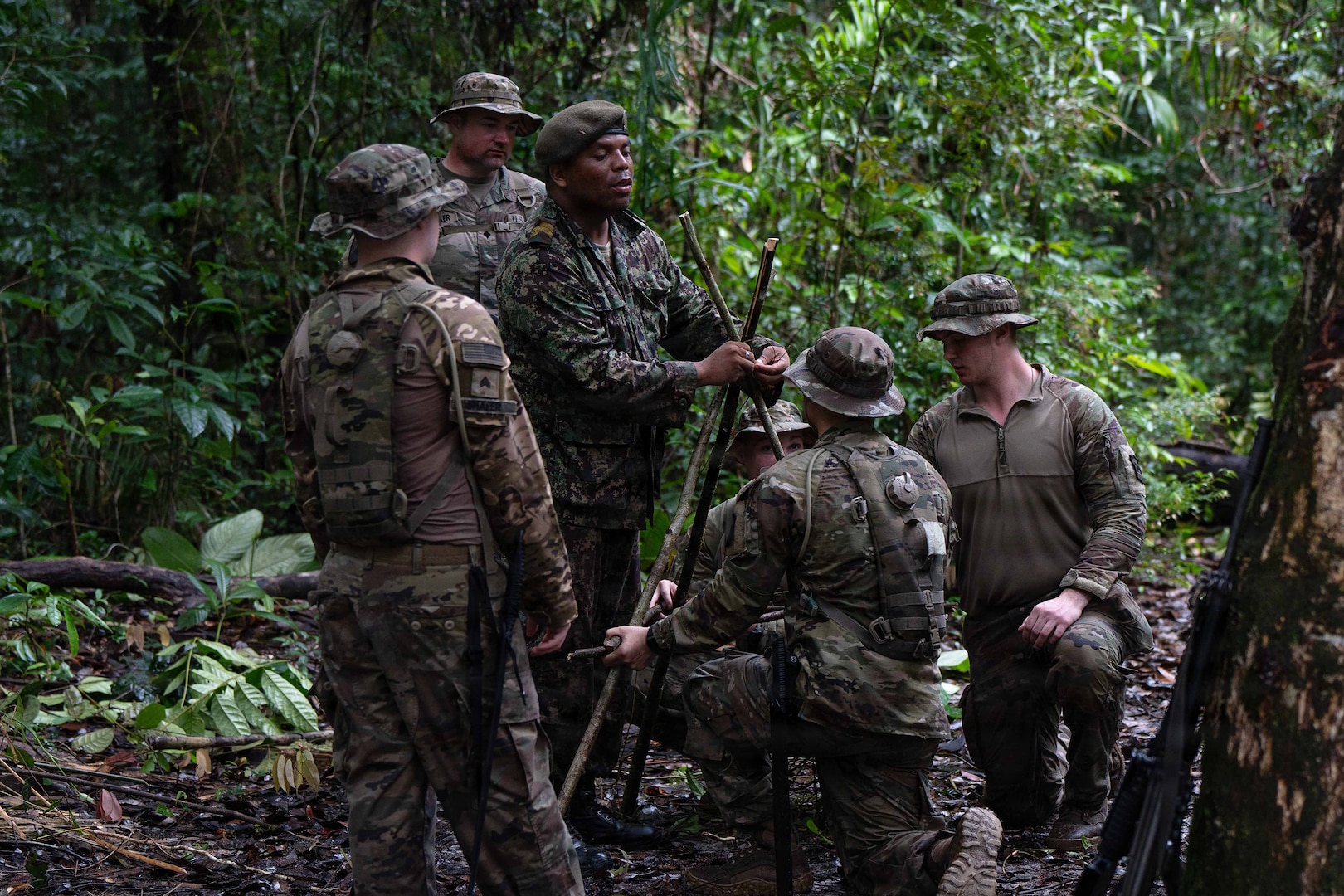 U.S. Soldiers and Airmen, along with members of the Suriname Armed Forces, construct survival structures during Operation Rumble in the Jungle at Ayoko, Suriname, April 17, 2026.