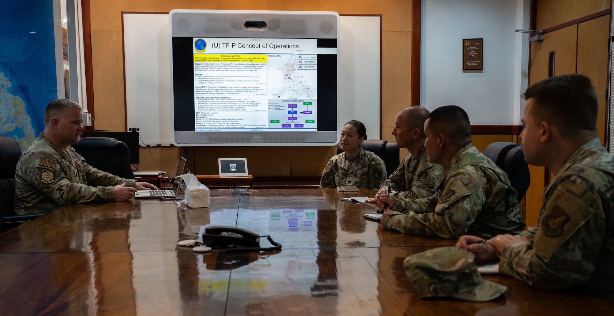 U.S. Air Force Lt. Col. David Nelson, left, chief of staff of Joint U.S. Military Assistance Group, and Lt. Col. Ashley Jung, center, deputy joint director of intelligence (J2), Task Force Philippines, speak to 21st Air Expeditionary Wing leadership during Exercise Balikatan 2026 at Manila, Philippines on April 23, 2026. Task Force-Philippines coordinates and synchronizes joint U.S. military support to the Armed Forces of the Philippines to achieve unity of effort enhancing AFP’s ability to achieve military, frequently collaborating with JUSMAG, enhancing partner air force capabilities through training, joint exercises and strengthening alliances and ensuring regional interoperability. Balikatan is a longstanding annual exercise between the Armed Forces of the Philippines and U.S. military that represents the strength of our alliance, improves our capable combined force, and demonstrates our commitment to regional peace and prosperity. (U.S. Air Force photo by Senior Airman Alondra Cristobal Hernandez)