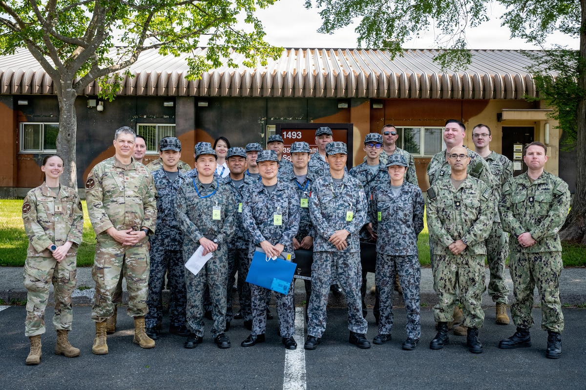 U.S. Airmen assigned to the 35th Munitions Squadron, Japan Air Self-Defense Force (JASDF) airmen assigned to the 3rd Air Wing and U.S. Navy Sailors assigned to the Naval Air Facility Misawa pose for a photo.