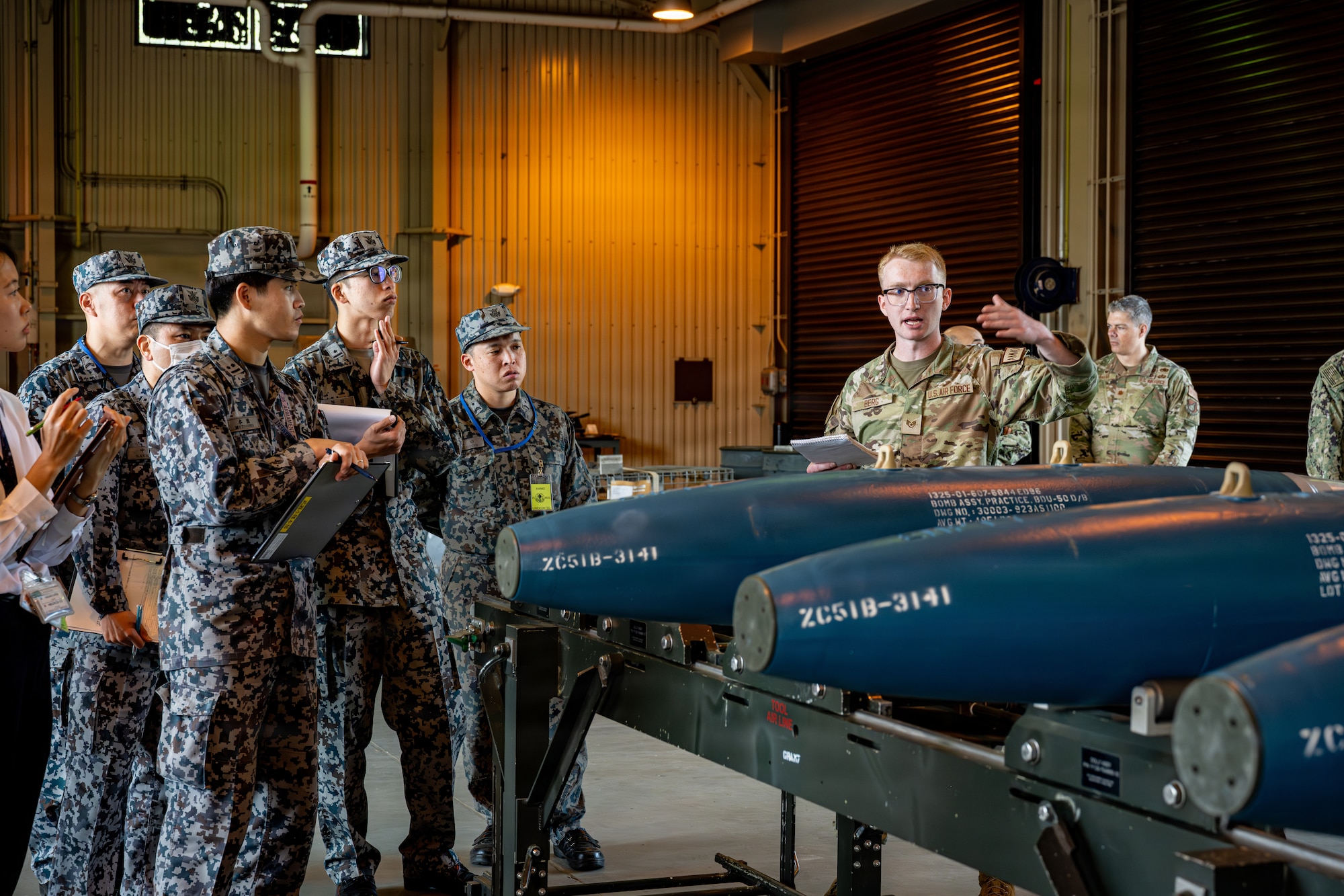 Japan Air Self-Defense Force airmen assigned to the 3rd Air Wing learn about the U.S. Air Force 35th Munition Squadron’s ammunition loading methods during an immersion tour.