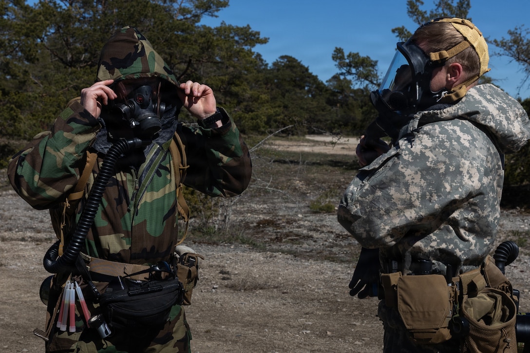 U.S. Marine Corps Sgt. Wyatt Cox, left, and Staff Sgt. Ian Heuer, both explosive ordnance disposal technicians with Combat Logistics Battalion 24, Combat Logistics Regiment 27, 2nd Marine Logistics Group, dawn mission oriented protective posture equipment during joint EOD and chemical, biological, radiological and nuclear training as part of exercise Aurora 26 in Visby, May 7, 2026. U.S. Marines and Sailors with 2nd MLG are participating in exercise Aurora as part of the larger U.S. Army-led Sword 26 series of linked multinational exercises, which directly supports NATO's Eastern Flank Deterrence Initiative concept, validates defense plans, builds a unified lethal force, and strengthens deterrence. Cox is a native of Texas. Heuet is a native of Hawaii. (U.S. Marine Corps photo by Lance Cpl. Talan Werner)