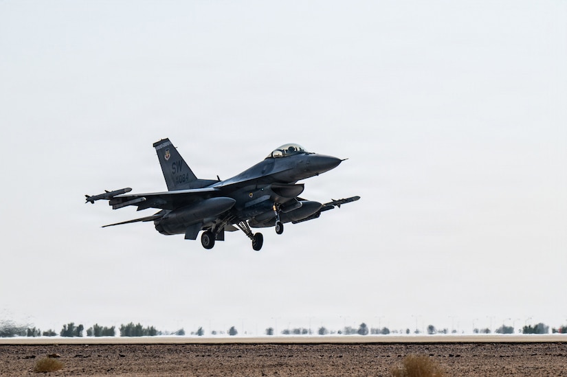 A military fighter jet takes off from a runway.