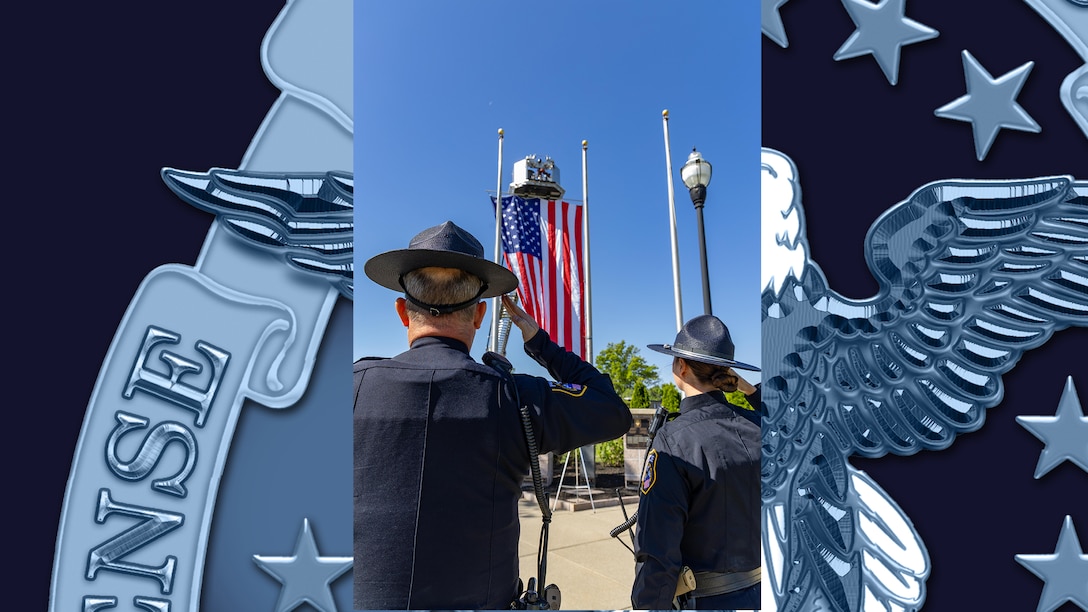 Two police officers face American flag and salute