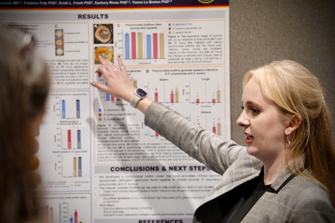 KISSIMMEE, Fla. (Aug. 5, 2025) Corley Mills, with Naval Medical Research Command (NMRC), presents a research poster at the 2025 Military Health System Research Symposium (MHSRS).