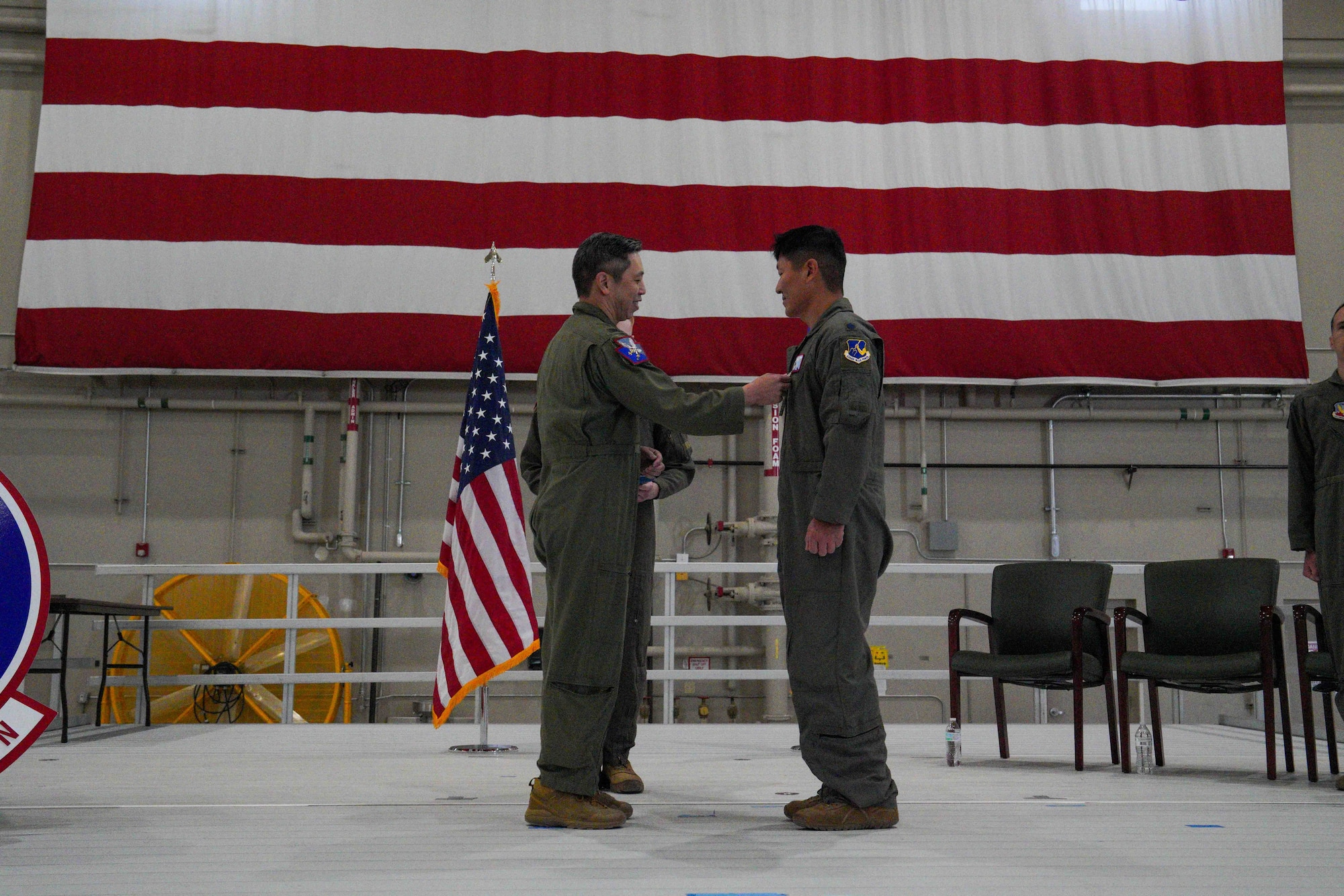 U.S. Air Force Col. Landon Quan, 25th Attack Wing deputy commander of operations, presents a Meritorious Service Medal to Lt. Col. Nathaniel Dull, 11th Attack Squadron outgoing commander, during a change of command ceremony at Creech Air Force Base, Nevada, April 17, 2026.