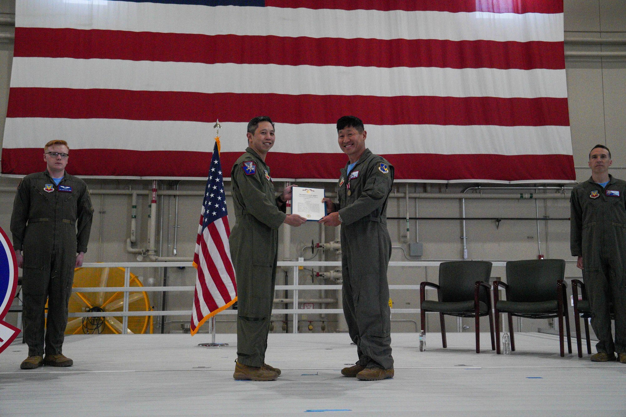 U.S. Air Force Col. Landon Quan, 25th Attack Wing deputy commander of operations, presents a Meritorious Service Medal to Lt. Col. Nathaniel Dull, 11th Attack Squadron outgoing commander, during a change of command ceremony at Creech Air Force Base, Nevada, April 17, 2026.