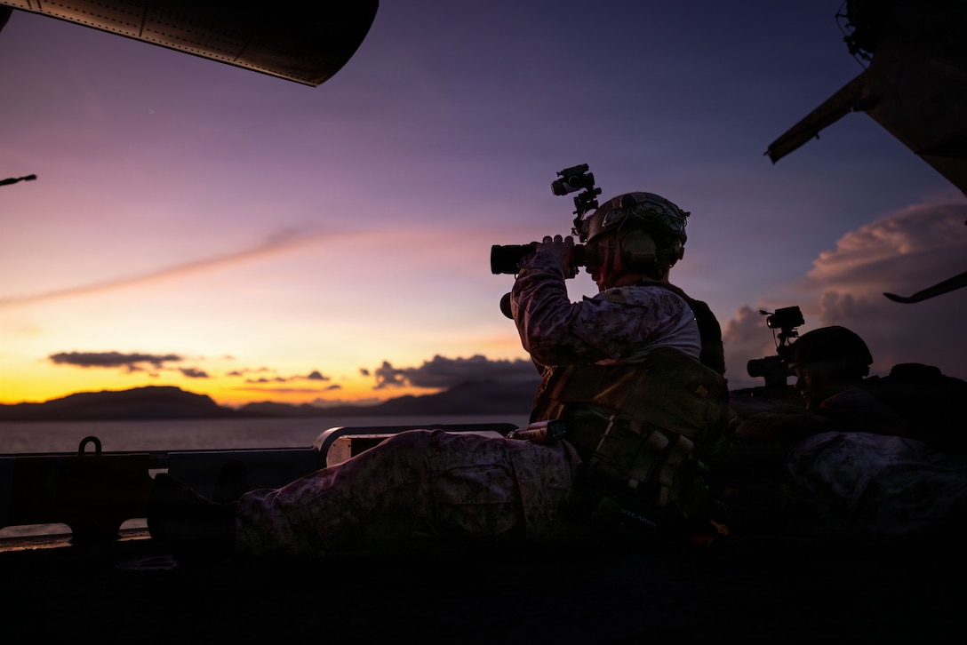 A U.S. Marine with Battalion Landing Team 3/5, 11th Marine Expeditionary Unit, scans for vessels on the flight deck of Wasp-class amphibious assault ship USS Boxer (LHD 4) while transiting the Balabac Strait, April 27, 2026. The 11th MEU, embarked aboard the Boxer Amphibious Ready Group, is a persistent, combat credible force contributing to deterrence and crisis response in the U.S. 7th Fleet area of operations. U.S. 7th Fleet, the U.S. Navy's largest forward-deployed numbered fleet, routinely interacts and operates with allies and partners to preserve a free and open Indo-Pacific. (U.S. Marine Corps photo by Sgt. Trent A. Henry)