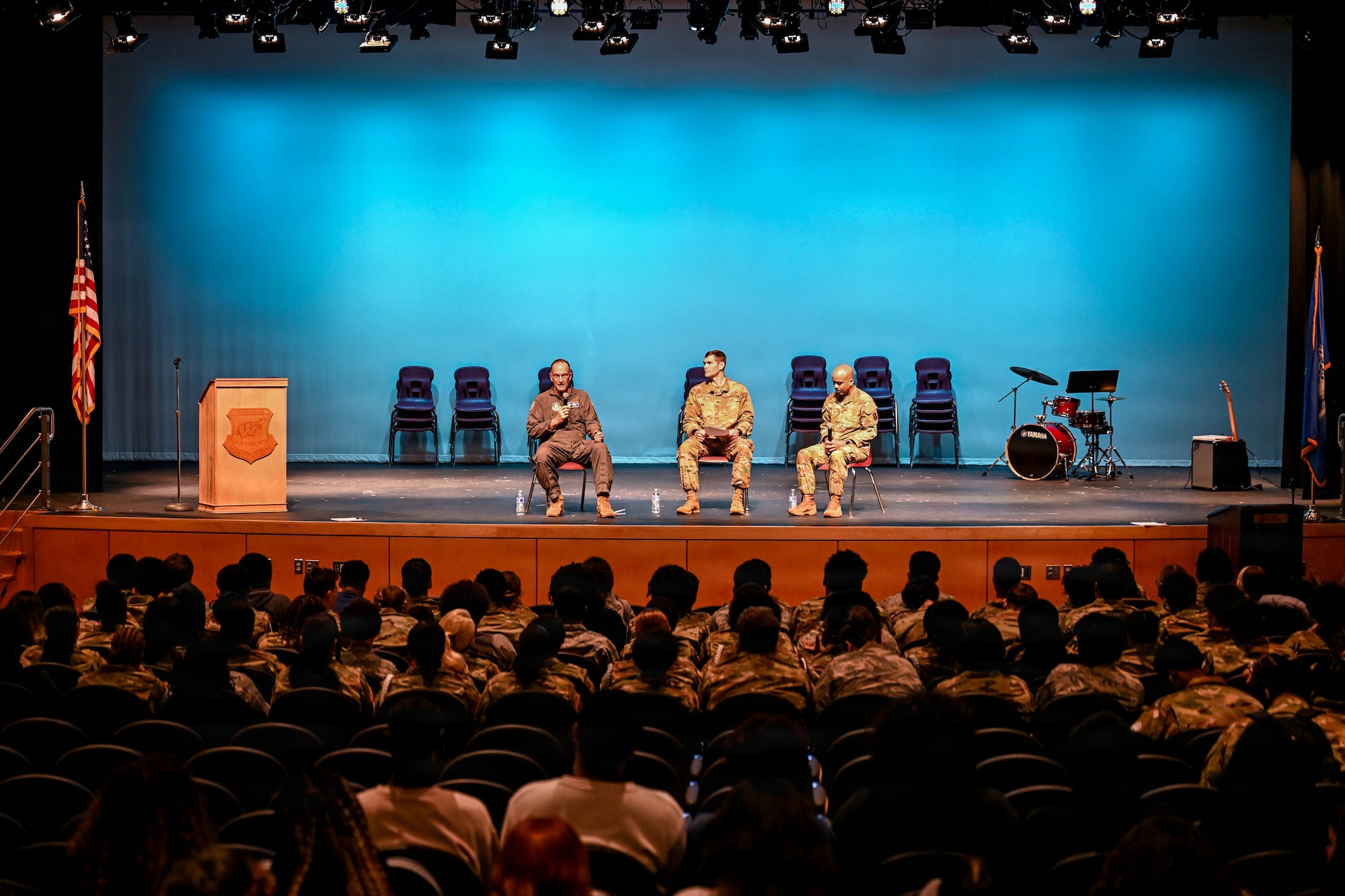 Senior leaders sit on stage