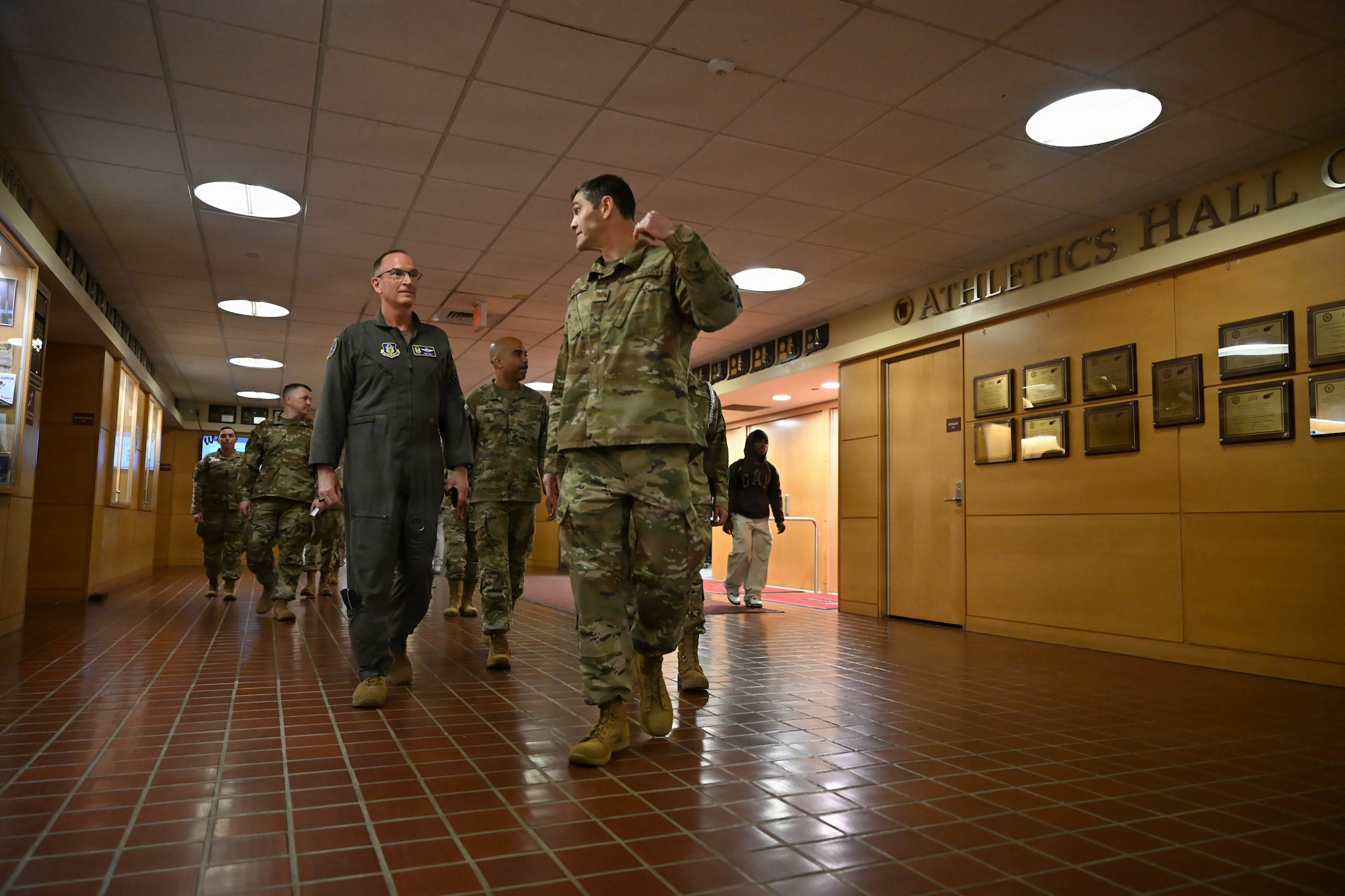 Service members walk through hallway