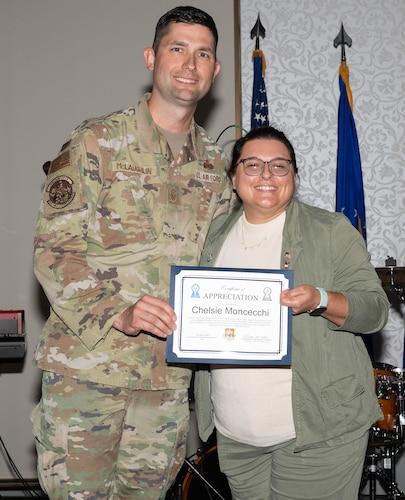 Woman receives an award from service member