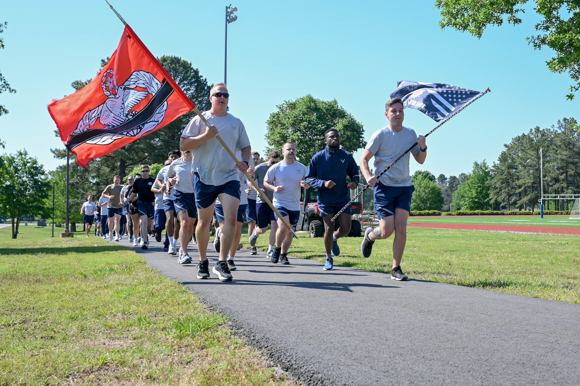 A group of people run in a line.